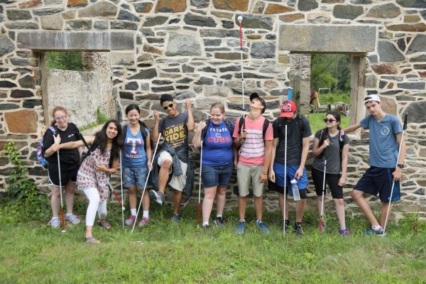 Students stand outside against a stone wall during the 2018 NFB EQ program.