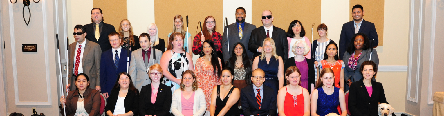 Scholarship Class Photo of 29 diverse blind students in three rows, Cricket is in the back row on the right