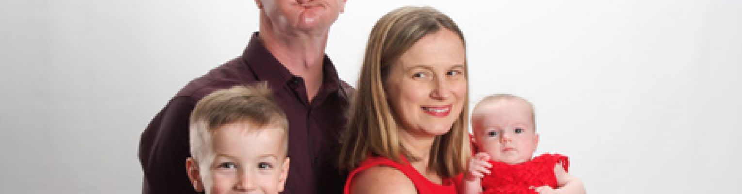 Stacy and her family pose for a family portrait. 