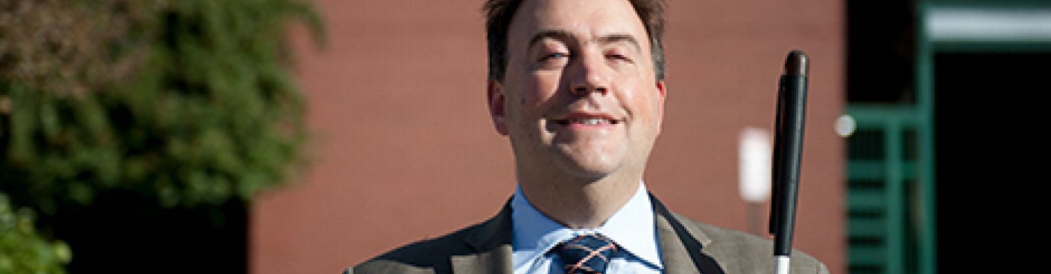 NFB President Mark A. Riccobono stands in front of the national headquarters in Baltimore.